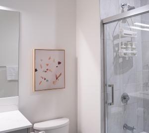 a bathroom with a shower and a picture on the wall at Forever Young by Revelstoke Vacations in Revelstoke