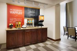 a waiting room with a counter with a coffee maker at Hampton Inn & Suites Tulsa South Bixby in Tulsa