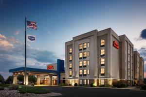 a hotel building with an american flag in front of it at Hampton Inn & Suites Pueblo-Southgate in Pueblo