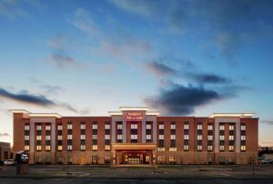 a large hotel with a sign on the front of it at Hampton Inn & Suites Chicago/Waukegan in Waukegan