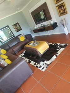 a living room with a couch and a table at 67@18th Avenue Beach View, in East London