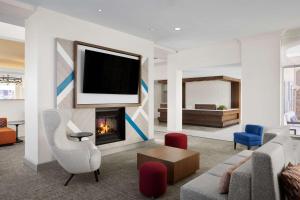 a living room with a couch and a fireplace at Hilton Garden Inn Las Vegas/Henderson in Las Vegas