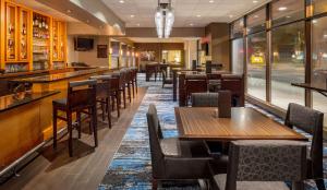 a restaurant with tables and chairs and a bar at DoubleTree Suites by Hilton Minneapolis Downtown in Minneapolis