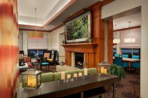 a living room with a couch and a fireplace at Hilton Garden Inn West Monroe in West Monroe