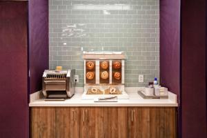 a doughnut shop with a counter with donuts on it at Tru By Hilton Smyrna Nashville in Smyrna