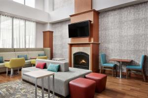 a living room with a couch and a fireplace at Hampton Inn & Suites West Haven in West Haven