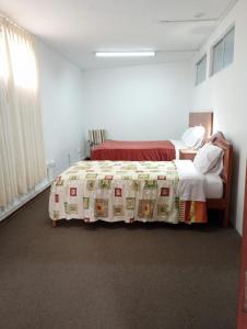 Łóżko lub łóżka w pokoju w obiekcie Hotel el sol de los incas