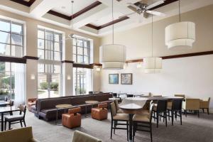 a dining room with tables and chairs and windows at Homewood Suites by Hilton Baltimore-Washington Intl Apt in Linthicum Heights