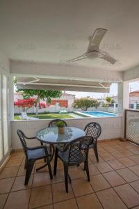 a patio with a table and chairs and a pool at Adaptados 32 in Vinaròs