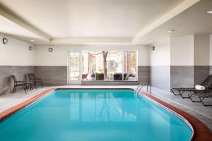 a swimming pool with blue water in a house at Hilton Garden Inn Providence Airport/Warwick in Warwick