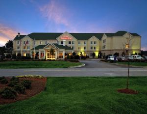 a large building with a sign on the front of it at Hilton Garden Inn Savannah Airport in Savannah