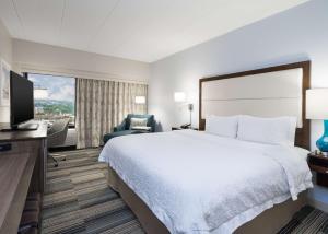 a hotel room with a bed and a television at Hampton Inn Pittsburgh University Medical Center in Pittsburgh