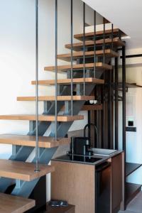 een keuken met houten trap in een kamer bij LANGO LUXURY LIVING s in Sivota
