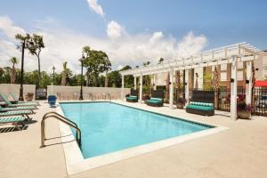 a swimming pool at a resort with lounge chairs and a building at Home2 Suites By Hilton Mt Pleasant Charleston in Charleston