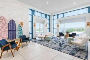 a waiting room with surfboards on the wall at Homewood Suites by Hilton Myrtle Beach Oceanfront in Myrtle Beach