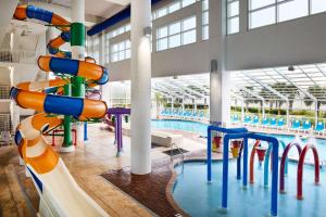 a large indoor swimming pool with a water slide at Homewood Suites by Hilton Myrtle Beach Oceanfront in Myrtle Beach