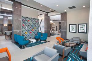 a waiting room with chairs and a wine rack at Hampton Inn & Suites LAX El Segundo in El Segundo