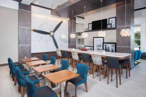 a dining room with blue chairs and a long table at Hampton Inn & Suites LAX El Segundo in El Segundo +50 photos