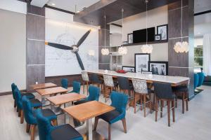 a dining room with tables and chairs and a bar at Hampton Inn & Suites LAX El Segundo in El Segundo