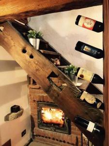 a room with a fireplace with a bunch of wine bottles at Appartamento "Verdjats" in Challand Saint Anselme +4 photos