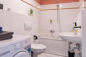 a white bathroom with a toilet and a sink at Studio THREE / Wifi / Netflix / 3 getrennte Betten in Chemnitz