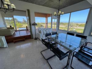 a living room with a glass table and chairs at Jose Ignacio, La Juanita frente al mar in José Ignacio