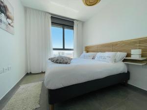 a bedroom with a large bed with a window at Savion View Apartment - Jerusalem City Center in Jerusalem
