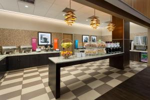 a restaurant with a counter with food on it at Hampton Inn Times Square Central in New York