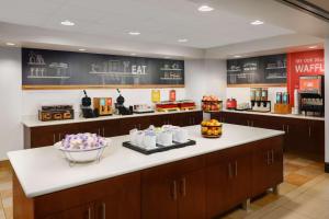 a kitchen with a counter with food on it at Hampton Inn & Suites West Sacramento in West Sacramento