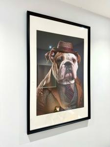 a picture of a dog wearing a hat and a tie at Stunning Brand New House - Sleeps 6 - Free Parking - Great Location - Fast WiFi - Smart TV - Close to Poole & Bournemouth & Sandbanks in Poole