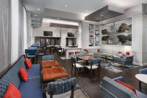 a restaurant with couches and tables and chairs at Hampton Inn Washington DC White House in Washington