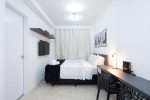 a bedroom with a bed and a desk in it at 360 Ascent Paulista in São Paulo +138 photos