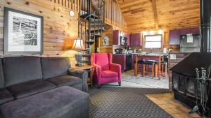 a living room with a couch and a kitchen at Christmas Mountain Campground in Wisconsin Dells
