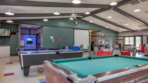 a billiard room with two pool tables in it at Christmas Mountain Campground in Wisconsin Dells