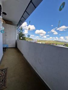 a balcony with a large window with a view at Sabina Apartment in Sighişoara