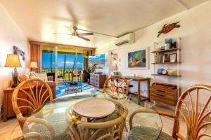 a living room with a glass table and chairs at MENEHUNE SHORES, #220 condo in Kihei