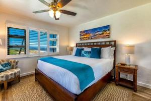 a bedroom with a bed and a ceiling fan at MENEHUNE SHORES, #220 condo in Kihei