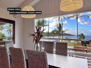 a dining area with a table with pineapple ocean views at Anahola Aloha Beach House home in Anahola