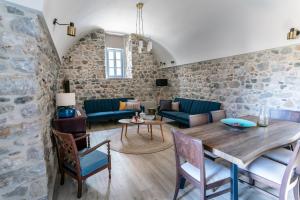 a living room with a wooden table and chairs at ENGLEZENA'S GUESTHOUSE in Leonidio