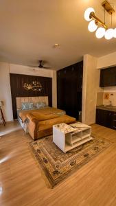 a large bedroom with a bed and a rug at Caramel DLF My Pad in Lucknow