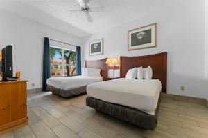 a hotel room with two beds and a television at Scottsdale upgraded 1 bd 1 ba 2 Queen Beds in Scottsdale