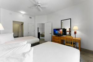 a hotel room with two beds and a flat screen tv at Scottsdale upgraded 1 bd 1 ba 2 Queen Beds in Scottsdale +19 photos