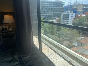 a room with a window with a view of a city at 8010 Urban Living- Luxury Home Experience in Bogotá