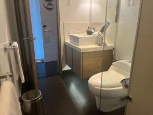 a bathroom with a white toilet and a sink at 8010 Urban Living- Luxury Home Experience in Bogotá