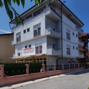 a white building with a fence in front of it at Vila Bolonja in Struga
