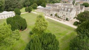 an aerial view of a large mansion with trees at Barton Hall Hotel & Spa in Kettering
