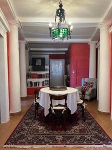 una sala da pranzo con tavolo e lampadario pendente di Castello ala Lucia a Monte Roberto