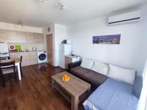 a living room with a couch and a table at Byala Apartments BSR 7 in Byala