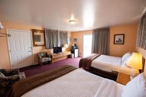 a hotel room with two beds and a television at Bells Melody Motel in Mackinaw City