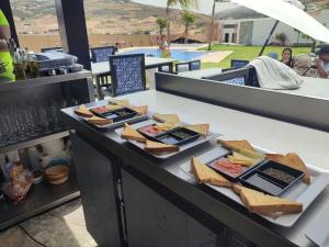 a buffet with bread and cheese on a table at CASA DEL TITO in Oulad Akkou